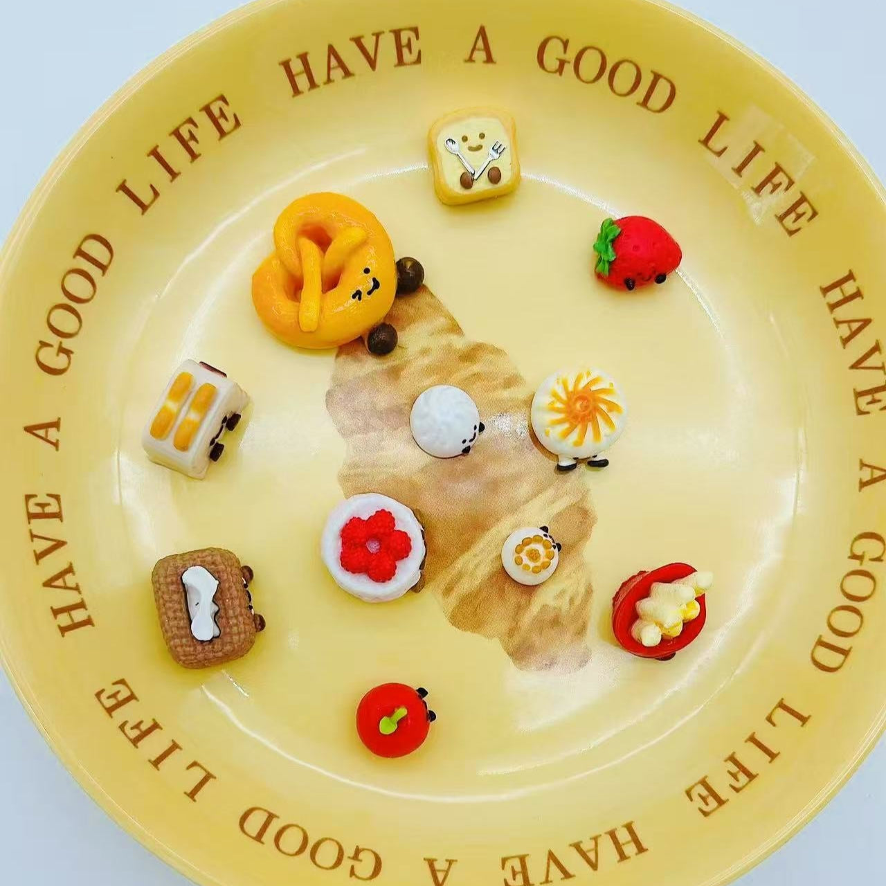 Top view of 11-piece JellyCat Taba Squishy Set featuring mini food-shaped characters like tissue box, toaster, pretzel, and dimsum.