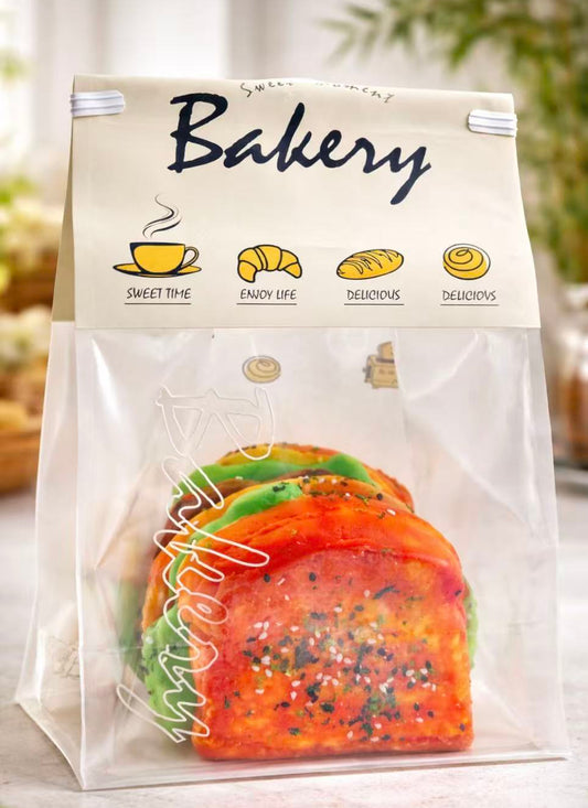 Handmade 6-layer jumbo sandwich toast taba squishy in bakery packaging, ultra realistic toast texture, soft slow rise collectible squishy toy
