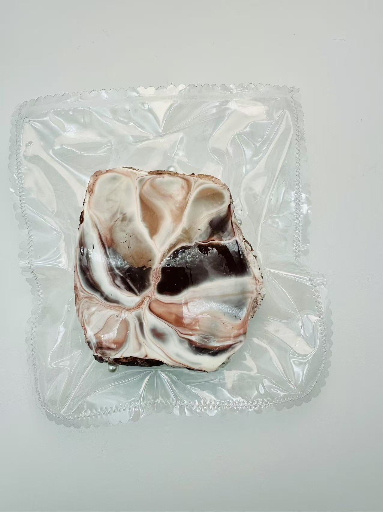 Back view of the handmade Chocolate Toast Taba Squishy showing intricate swirl details and soft texture, wrapped in transparent packaging.