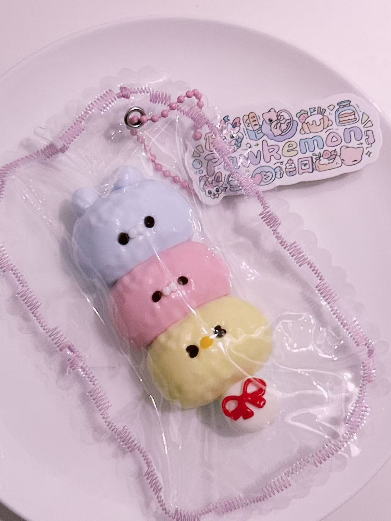 Side view of Cute Animal Stack Taba Squishy with pastel animal stack design, handmade silicone texture and delicate stitched packaging details