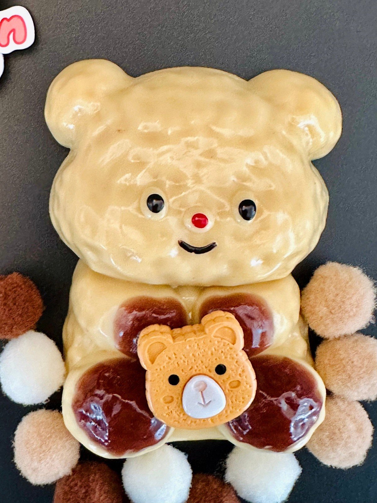 Close-up of Honey Hug Bear squishy with accessories, highlighting its cozy and playful design for kawaii toy collectors.