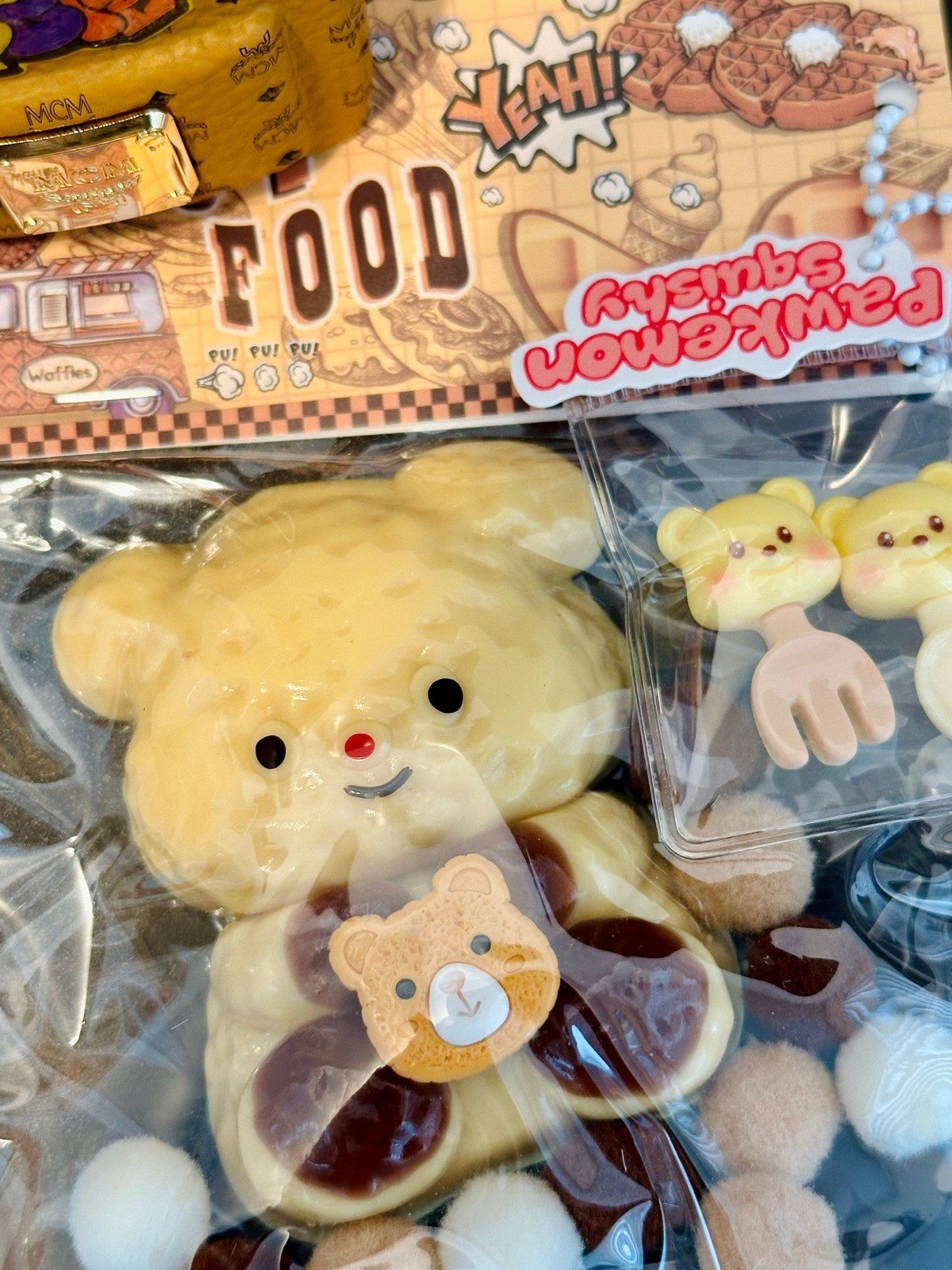 Honey Hug Bear squishy in packaging box, showcasing adorable bear design with honey-themed details and pastel color palette.