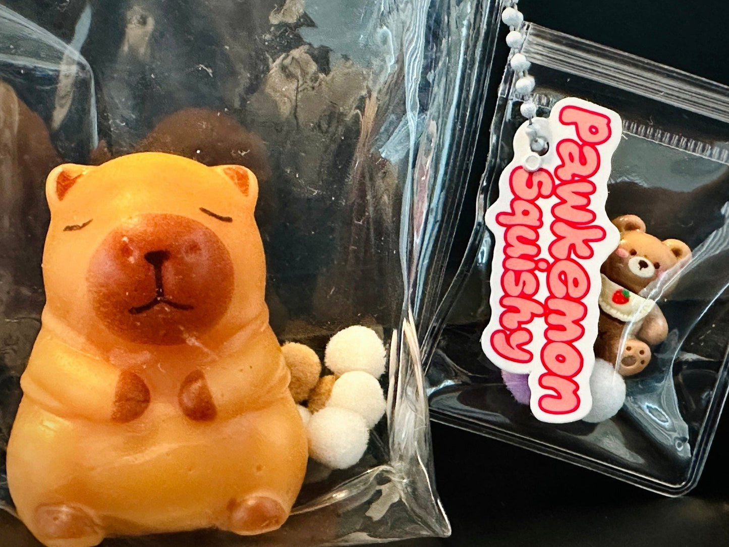 Close-up of sage capybara squishy packaging, highlighting adorable sleepy capybara design with cozy and relaxing vibes.