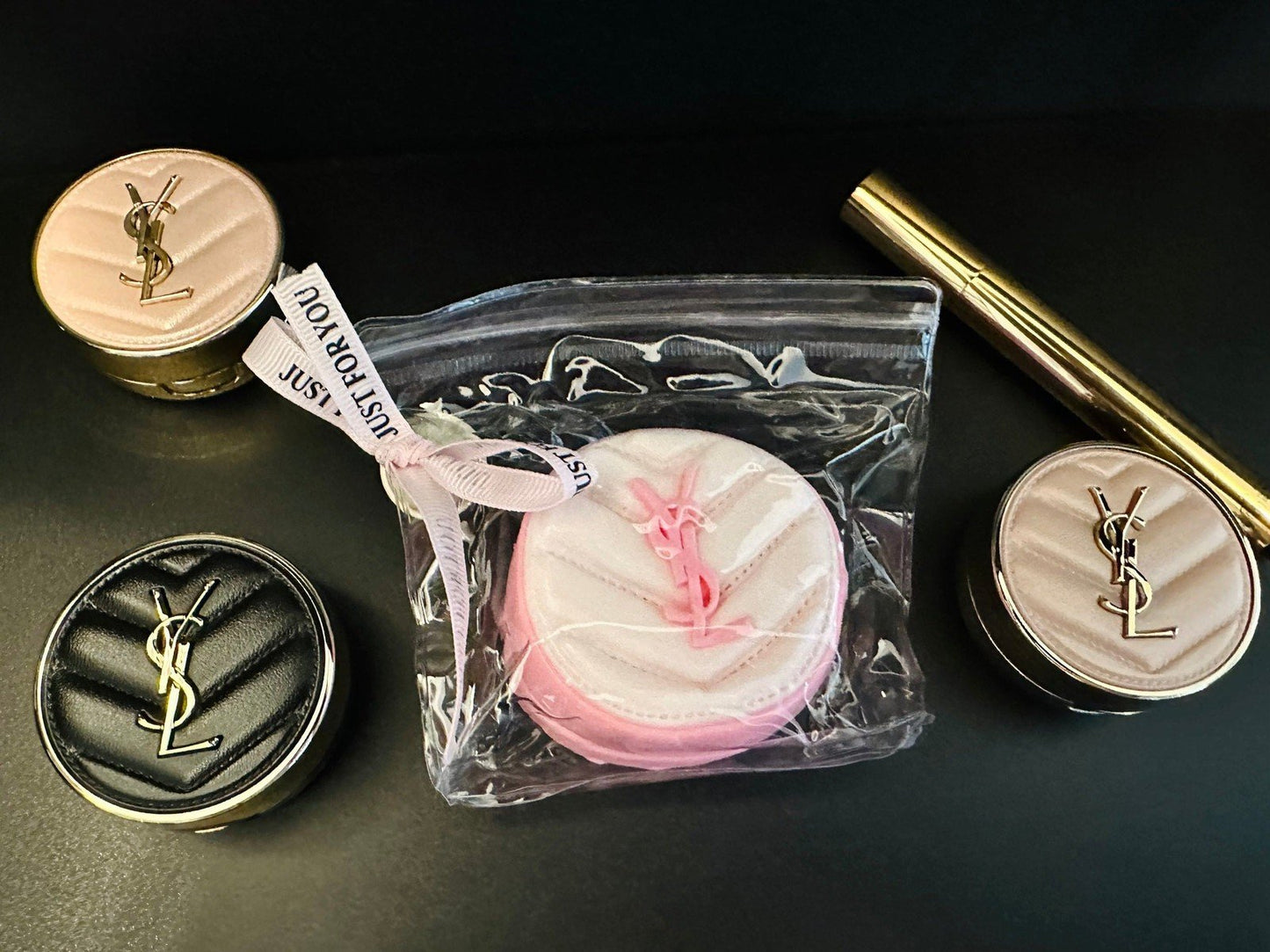 Le Cushion squishy styled with brushes and compact powder in a beauty flat lay setup