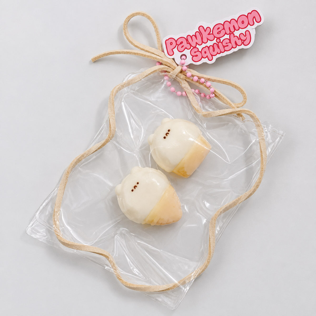 Two-piece mini hamster ice cream Taba squishy set in a clear PVC display bag with beige trim, photographed from above on a white plate.