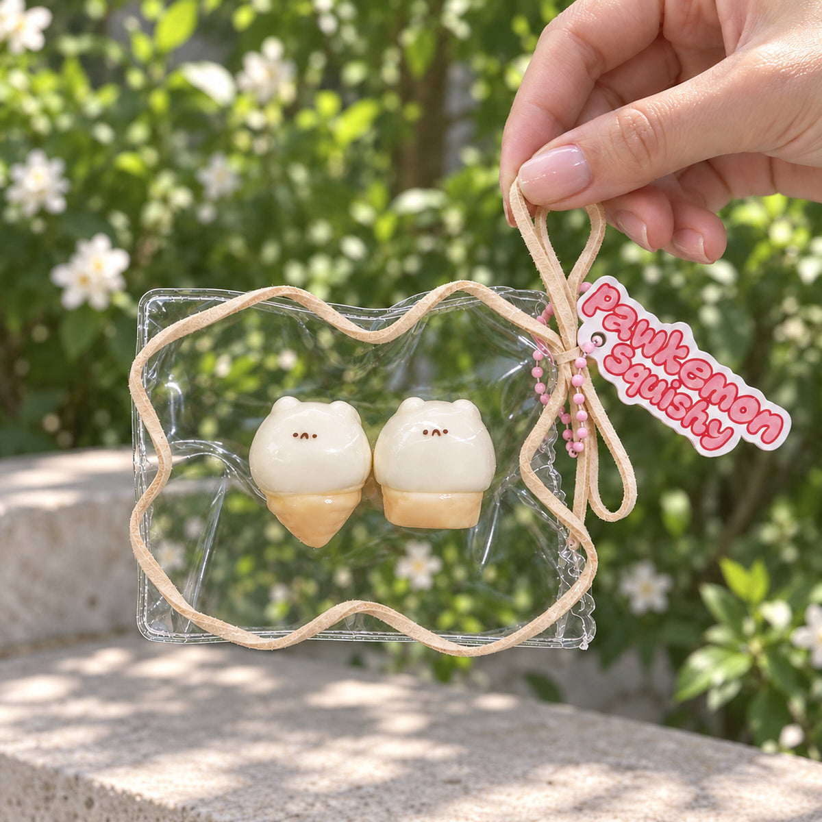 Two-piece mini hamster ice cream Taba squishy set in a clear PVC display bag with beige trim, photographed from above on a white plate.