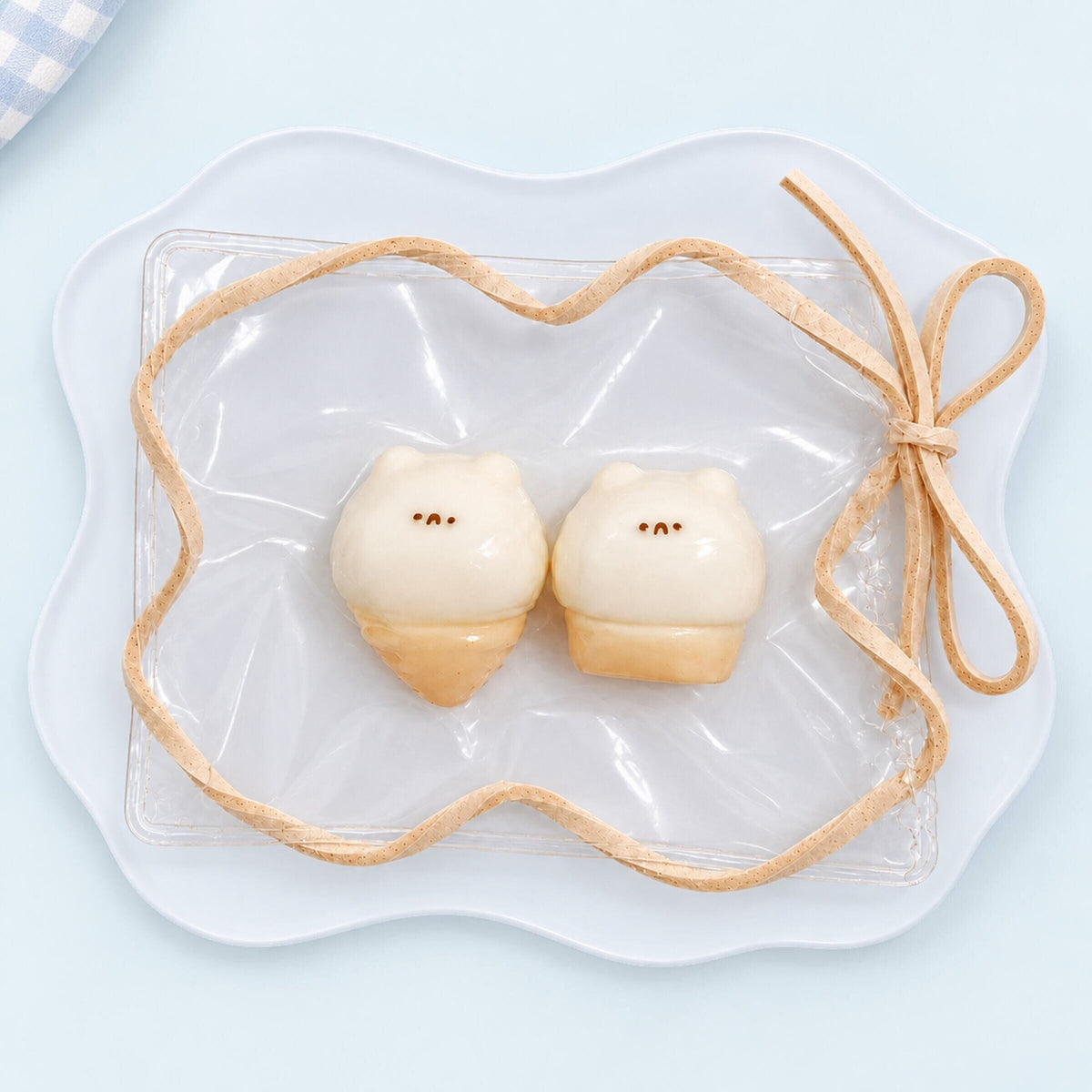 Two-piece mini hamster ice cream Taba squishy set in a clear PVC display bag with beige trim, photographed from above on a white plate.