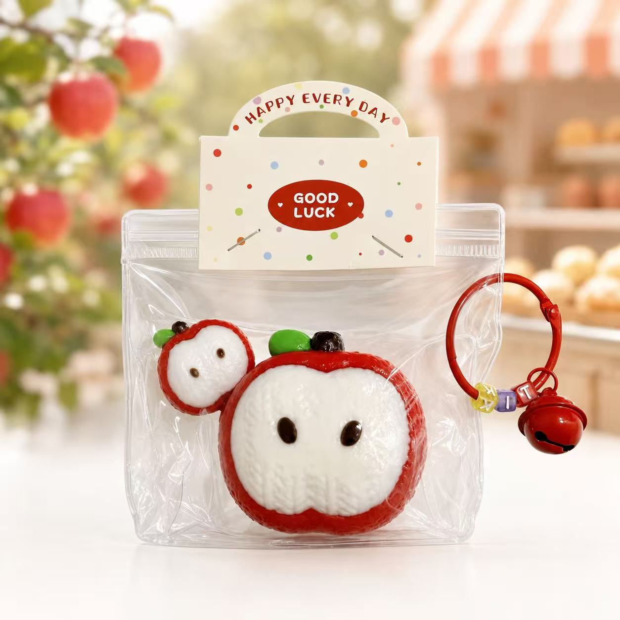 2pc Knitted Apple Taba Squishy by Pawkemon Squishy, a handmade silicone apple squishy set with knitted-style texture, red apple slice design, clear packaging, and red bell charm.