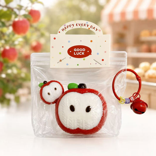 2pc Knitted Apple Taba Squishy by Pawkemon Squishy, a handmade silicone apple squishy set with knitted-style texture, red apple slice design, clear packaging, and red bell charm.