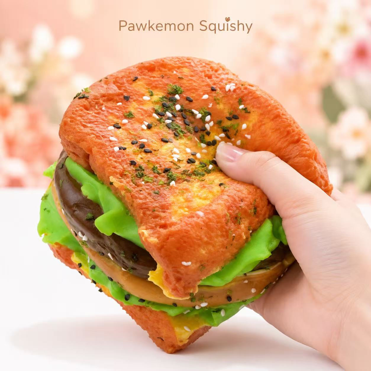Hand holding the 6-Layer Jumbo Sandwich Taba Squishy, showing its jumbo size, soft handmade silicone texture, and realistic layered sandwich design.