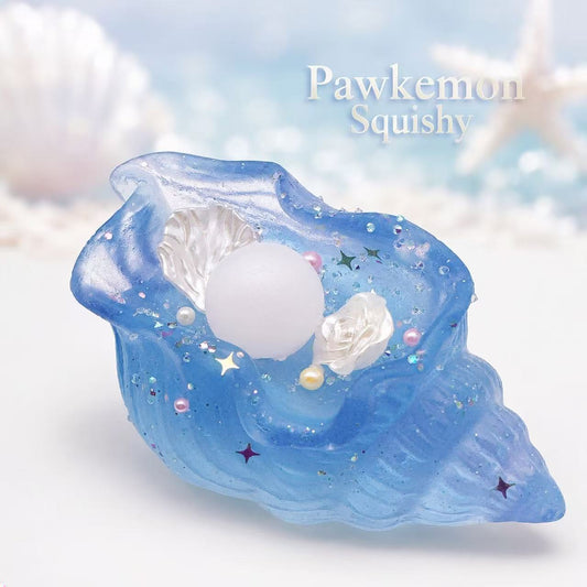 Blue shell-shaped squishy toy with white center and star decorations on a light blue background.