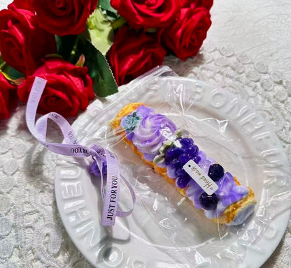 Handmade Creamy Grape Horn Squishy with purple cream swirls and grape toppings on a golden pastry horn.