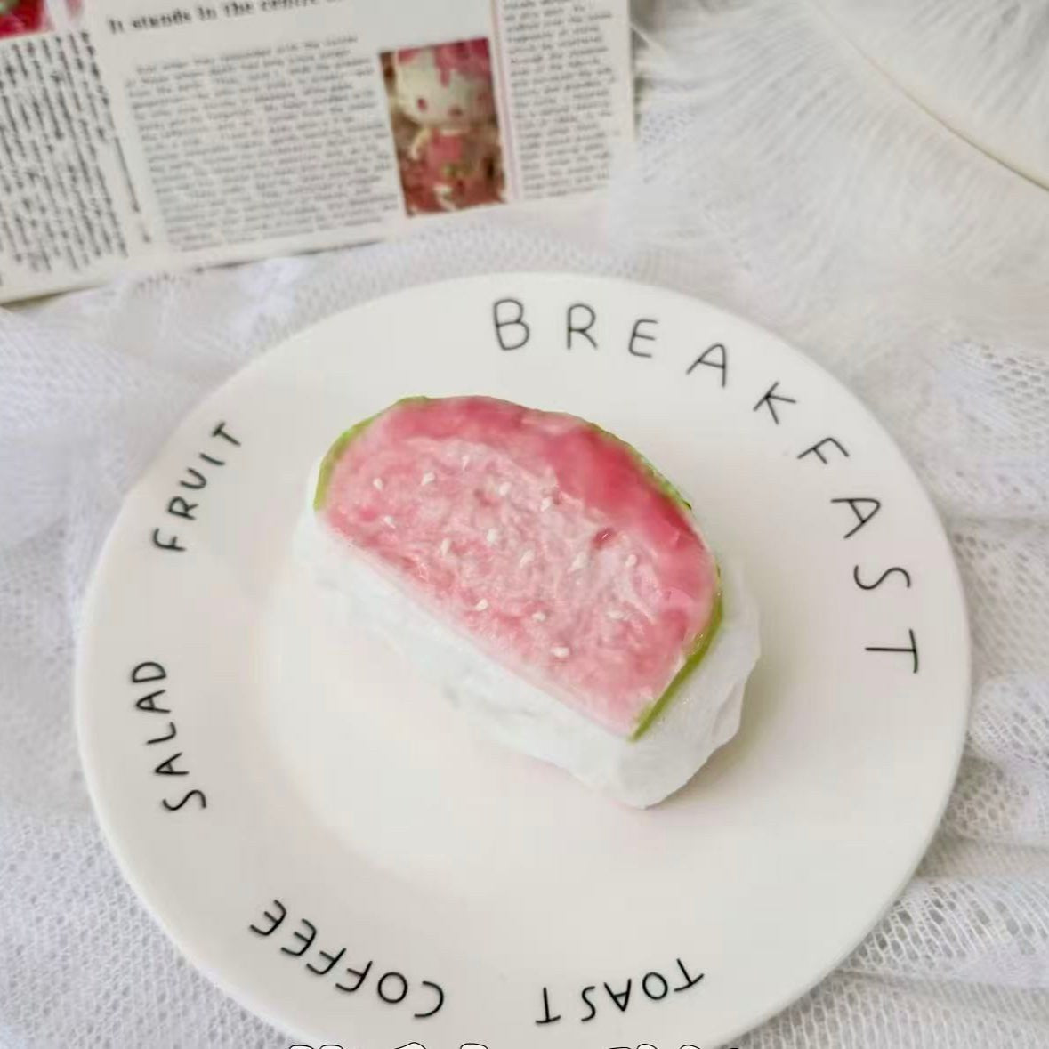 A handmade guava soufflé squishy with soft pink guava top and white soufflé cake base, realistic dessert-style stress toy.