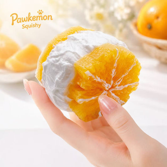 Pawkemon Squishy toy shaped like a sliced orange held by a hand on a light background.