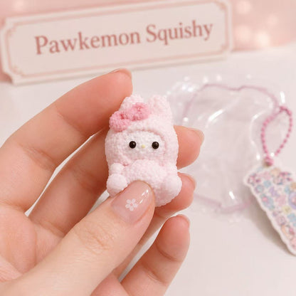 Close-up of the Pink Bunny Taba Squishy showing its detailed pink bow, textured handmade surface, glossy black eyes, and soft pastel finish.