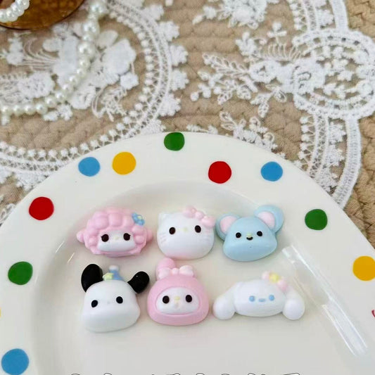 Six pastel-colored Sanrio-inspired mini squishies, arranged on a  white plate.
