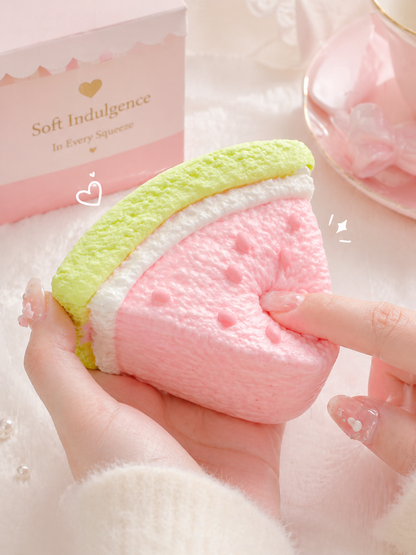 Pawkemon Watermelon Cake Taba Squishy held by a hand with a soft background