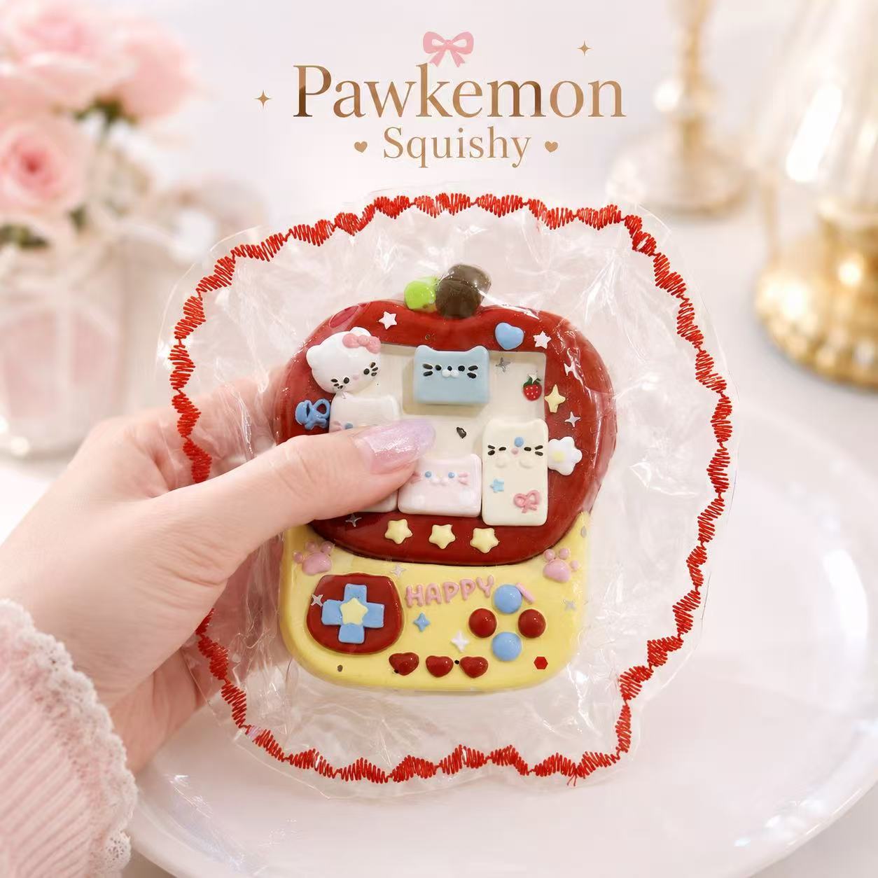 Hand holding a handmade Arcade Machine Taba Squishy with colorful buttons, game screen details, and a soft silicone texture
