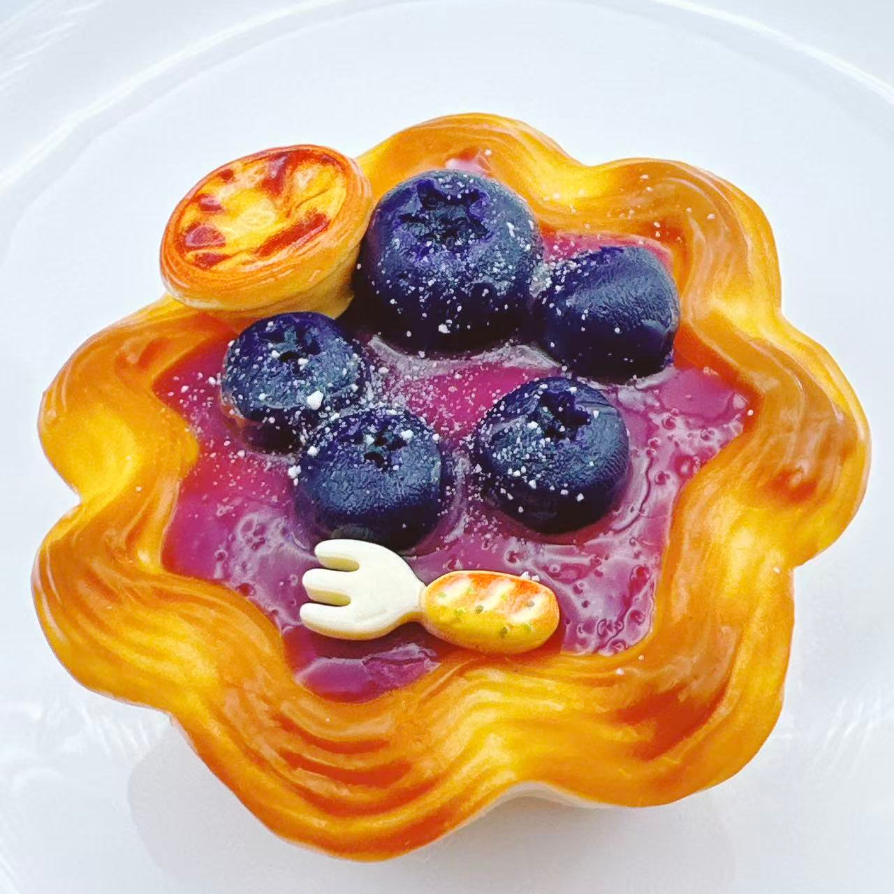 Handmade blueberry cream tart taba squishy with glossy silicone blueberry topping, golden tart crust and realistic fruit details, luxury dessert style stress relief toy