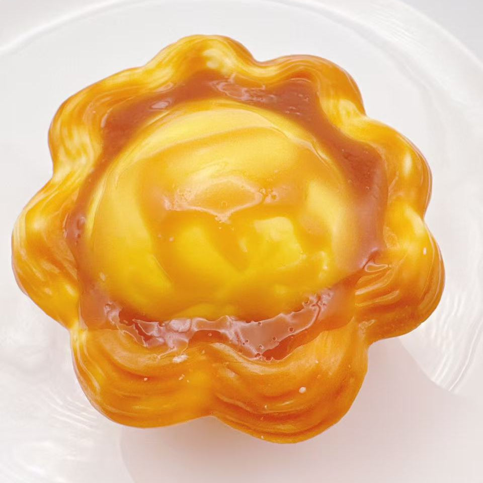 Handmade classic egg tart taba squishy with glossy custard center, golden flaky tart crust and ultra realistic silicone dessert texture, luxury stress relief toy