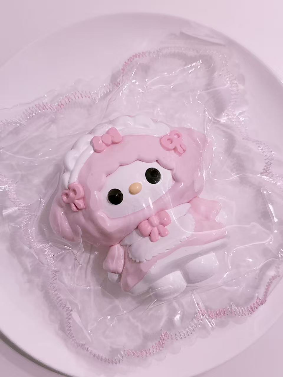 Close-up view of Cosplay Melody Taba Squishy, handmade silicone squishy featuring pink cosplay outfit and delicate packaging details
