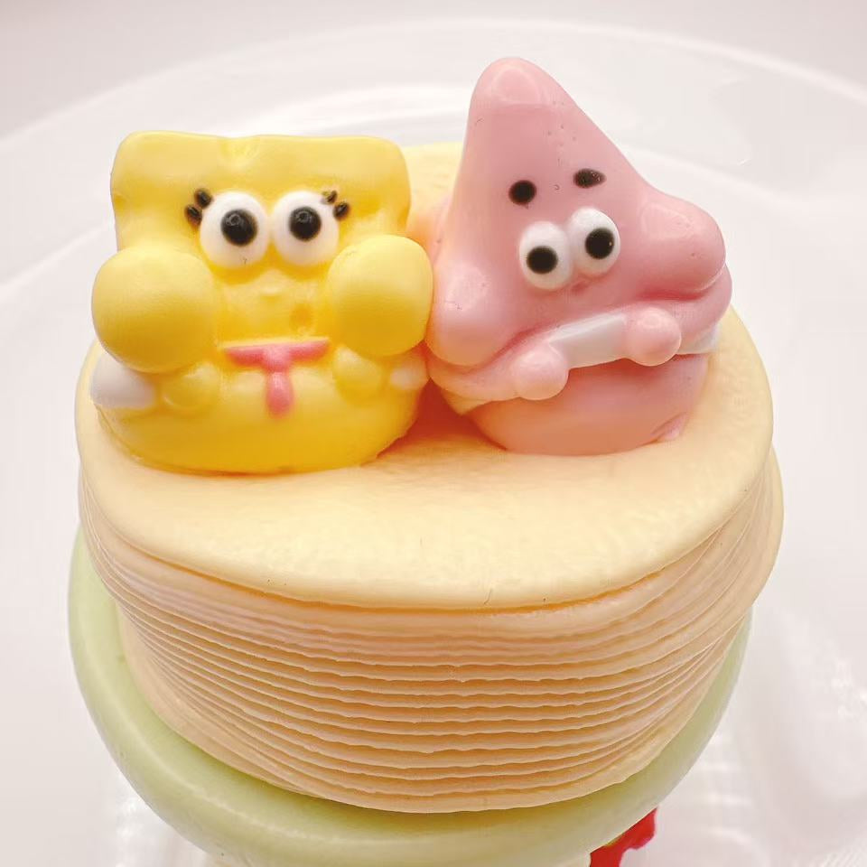 Close-up of Crispy Buddy Chips Taba Squishy showing two adorable cartoon buddies on layered potato chips, soft handmade silicone squishy texture