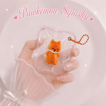 A delicate feminine hand holding the packaged Fox Taba Squishy, showing the orange fox design, clear PVC pouch, pink stitched border, and orange bead chain.