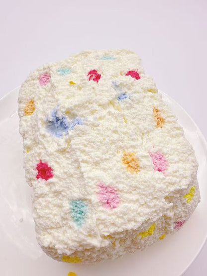 Side view of gummy bear toast taba squishy with colorful confetti texture, handmade silicone squishy, soft slow rise ASMR toy