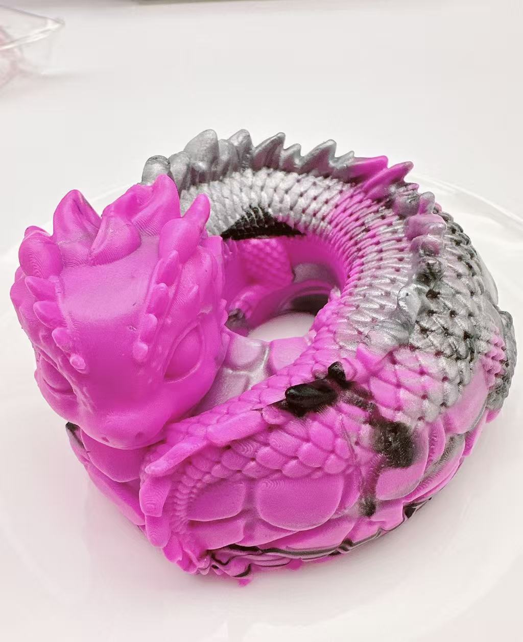 Handmade pink dragon coil taba squishy made of silicone, fantasy dragon sensory toy with detailed scales and coiled shape