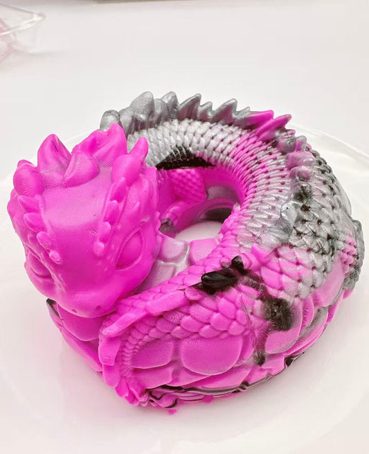Handmade pink dragon coil taba squishy made of silicone, fantasy dragon sensory toy with detailed scales and coiled shape