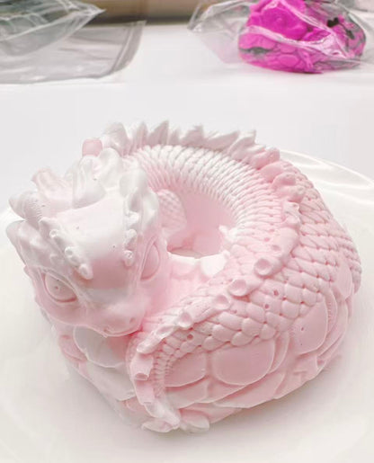 Handmade dragon coil taba squishy photographed during creation, showing detailed silicone craftsmanship