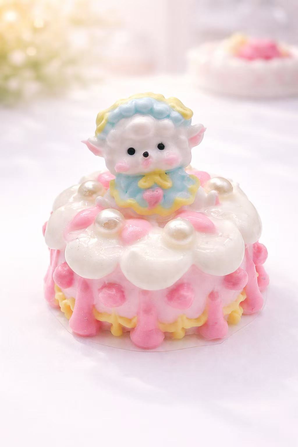 Handmade Lamb Pearl Cake Taba Squishy with a pastel lamb figure, pearl-like decorations, pink frosting, and flower details