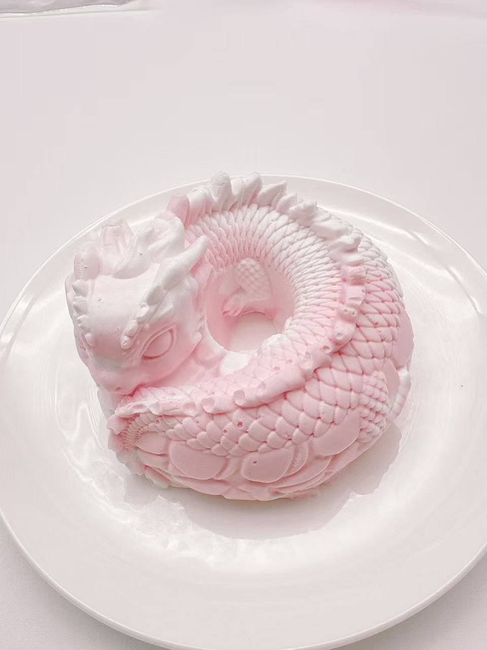 Light pink dragon coil taba squishy made from handmade silicone, fantasy dragon sensory stress toy