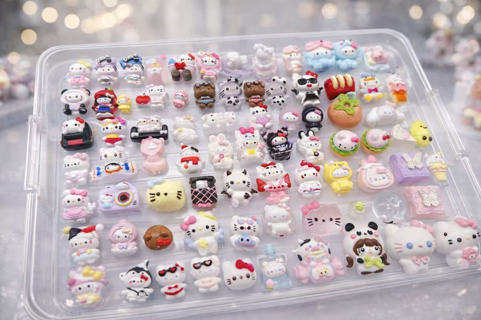 Assorted handmade Luxe Mini Taba Squishy figures arranged in a clear box, showcasing the variety inside the mystery box