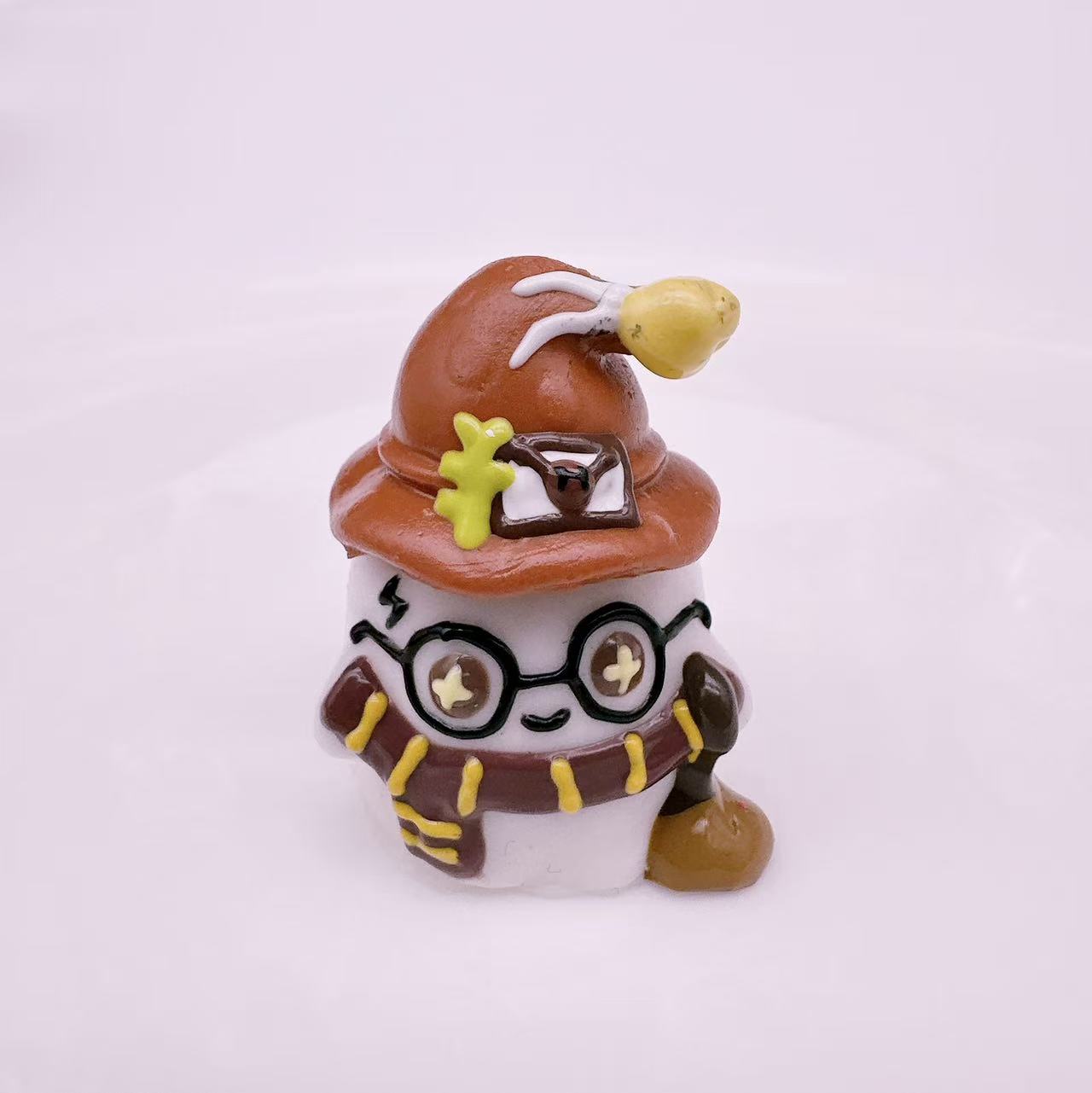 Side view of a handmade magic academy wizard taba squishy showing detailed hat glasses and silicone texture
