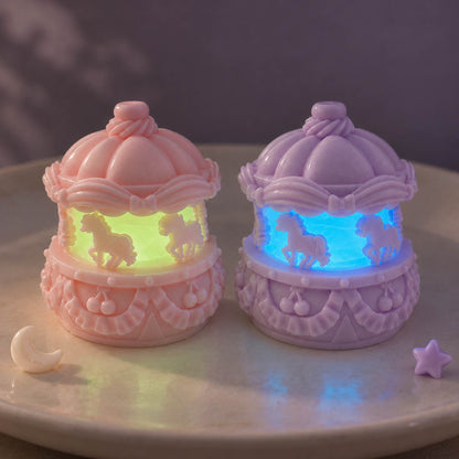 Pink and lavender mini carousel Taba Squishies with translucent centers glowing yellow-green and blue in the dark.