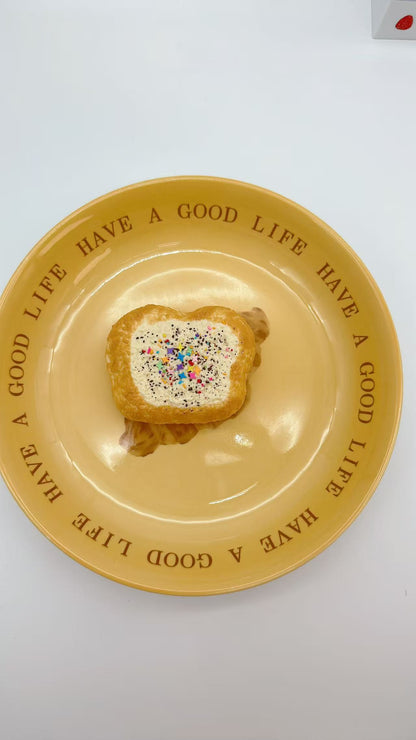 Top view of Mini Toast Taba Squishy with whipped topping and rainbow sprinkles.