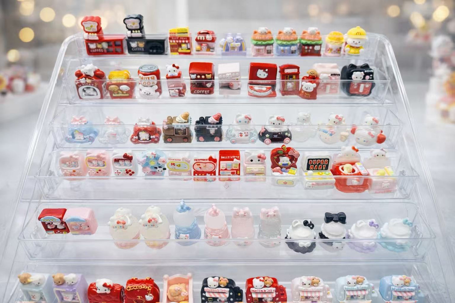 Pawkemon mini taba squishy collection displayed on a clear stand, featuring handmade food-grade silicone squishies in cute collectible designs