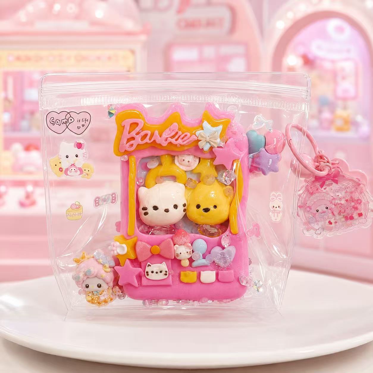 Handmade pink Claw Machine Taba Squishy in transparent packaging with plush character figures and colorful arcade details