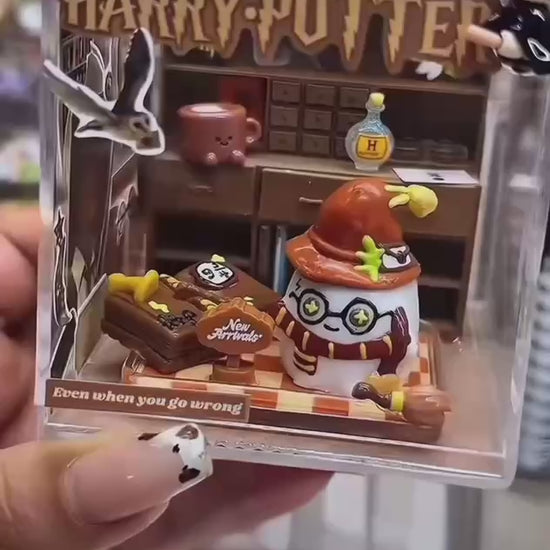 Video showing a handmade magic academy case taba squishy inside a clear acrylic display box from multiple angles

