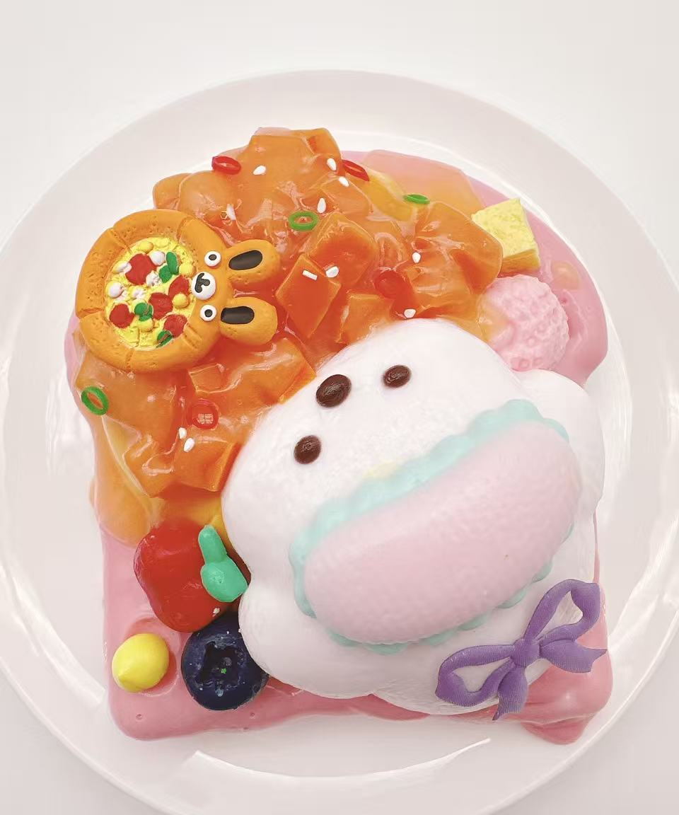 Top view of puppy salmon toast taba squishy with salmon-inspired topping, fruit accents and soft creamy handmade silicone texture
