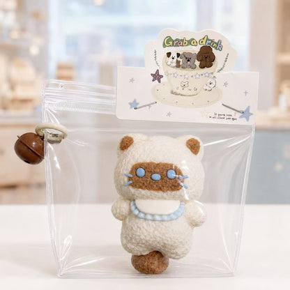 Siamese Cat Taba Squishy by Pawkemon Squishy, a handmade silicone cat squishy with soft fluffy texture, blue collar detail, clear packaging, and cute bell charm.