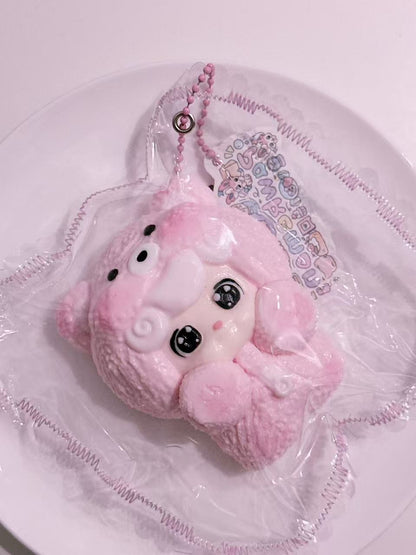 Side view of Sleepy Baby Taba Squishy in pajamas, handmade silicone squishy with gentle sleepy expression and decorative sewn packaging