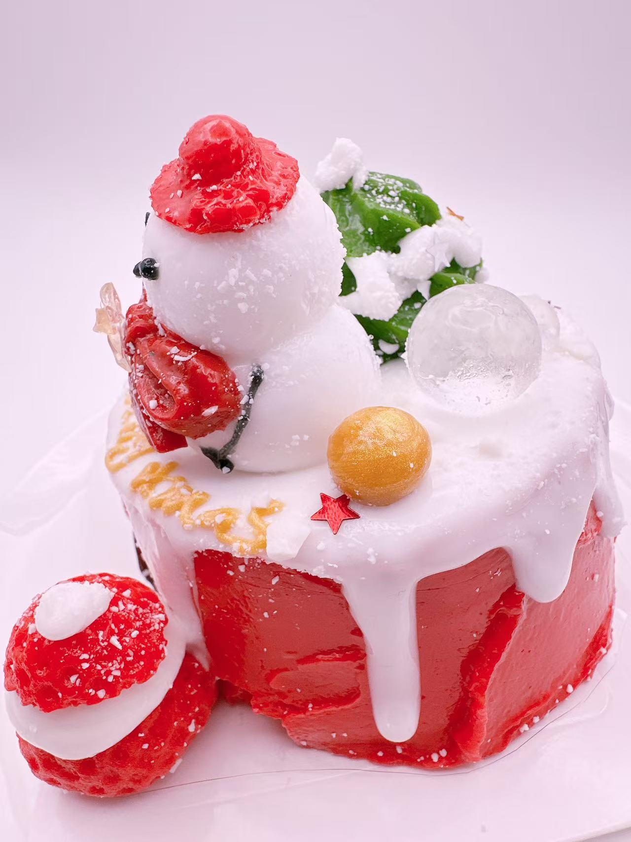 Strawberry Christmas cake taba squishy featuring snowy icing drips and double snowman design