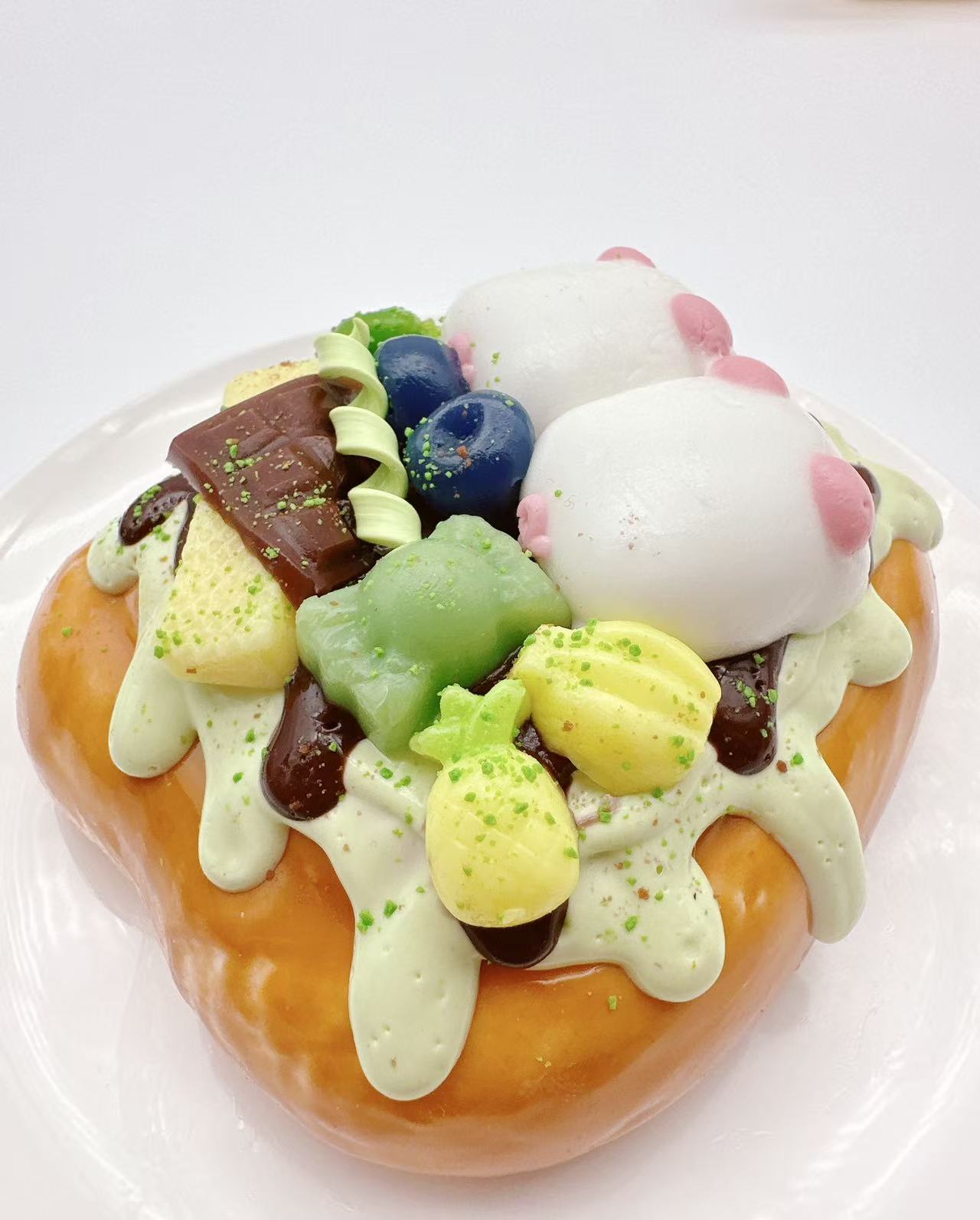 Side view of two pigs dessert toast taba squishy, handmade silicone squishy featuring chocolate sauce, sweets, fruit toppings and kawaii pig characters
