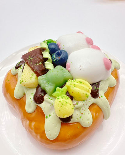 Side view of two pigs dessert toast taba squishy, handmade silicone squishy featuring chocolate sauce, sweets, fruit toppings and kawaii pig characters
