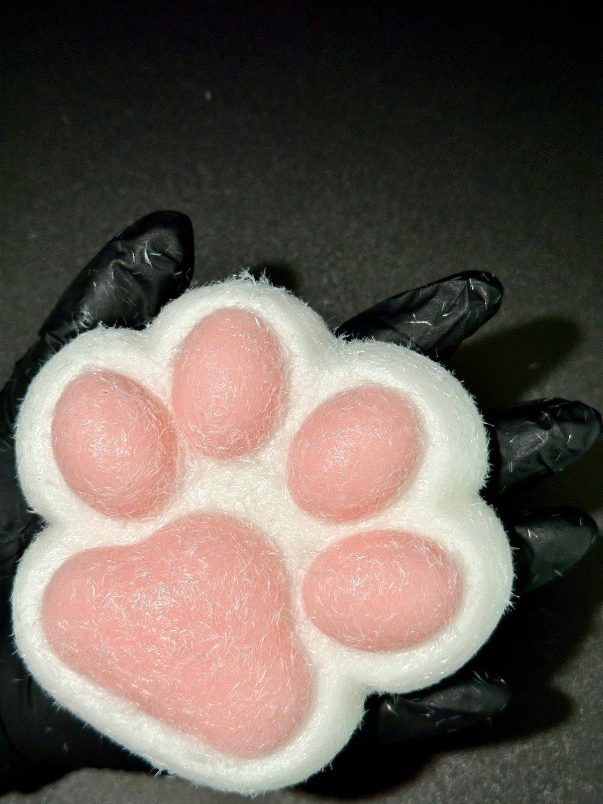 Side angle close-up of ultra soft cat paw squishy with detailed pink pads and extra fluffy material, great for stress relief and cute display.