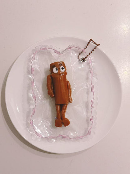 Handmade Wooden Man Taba Squishy in transparent packaging with a simple brown character design